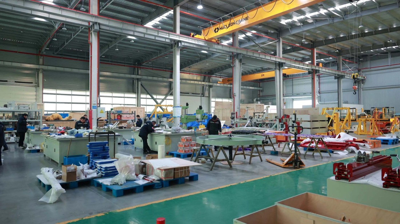 Distant view of assembly worker scaled